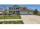 Charming two-story home with a brick and siding exterior, well-manicured lawn, and a three-car garage at 22197 E Stroll Ave, Parker, CO 80138