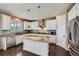 Bright kitchen with stainless steel appliances, granite countertops, and a center island with seating at 22197 E Stroll Ave, Parker, CO 80138