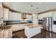 Bright kitchen with stainless steel appliances, granite countertops, and a center island with seating at 22197 E Stroll Ave, Parker, CO 80138