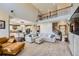 Bright, open-concept living room featuring high ceilings, large windows, and seamless flow to the kitchen and dining area at 22197 E Stroll Ave, Parker, CO 80138