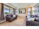 Comfortable living room featuring neutral carpet, large windows, and stylish sofas with decorative pillows at 22197 E Stroll Ave, Parker, CO 80138