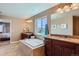 Luxurious main bathroom featuring dual vanities, a soaking tub, granite countertops, and decorative mirrors at 22197 E Stroll Ave, Parker, CO 80138