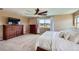 Spacious main bedroom with a large window, ceiling fan, and hardwood furniture at 22197 E Stroll Ave, Parker, CO 80138