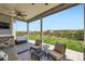 Inviting covered outdoor patio with comfortable seating, a porch swing, and a peaceful backyard vista at 22197 E Stroll Ave, Parker, CO 80138