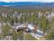 Beautiful aerial view of the home in a wooded area with mountain views at 28592 Hummingbird Hill Rd, Conifer, CO 80433