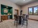 Basement game area featuring a bar area, gas fireplace and exterior views at 28592 Hummingbird Hill Rd, Conifer, CO 80433