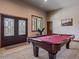 Finished basement featuring a pool table and exterior views at 28592 Hummingbird Hill Rd, Conifer, CO 80433