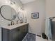 Bathroom featuring double sinks, updated hardware, and framed art at 28592 Hummingbird Hill Rd, Conifer, CO 80433