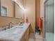 Modern bathroom featuring a stylish double vanity with marble countertops, modern fixtures, and a glass-enclosed shower at 28592 Hummingbird Hill Rd, Conifer, CO 80433