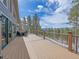 Expansive deck with railing offering views of the mountains and foliage, perfect for outdoor dining and lounging at 28592 Hummingbird Hill Rd, Conifer, CO 80433