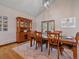 Formal dining room with wooden table and chairs, hutch, and light fixture, providing an elegant dining experience at 28592 Hummingbird Hill Rd, Conifer, CO 80433