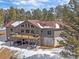 Beautiful two-story home featuring a large deck, walkout patio, and attached three-car garage at 28592 Hummingbird Hill Rd, Conifer, CO 80433