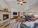 Inviting living room with a stone fireplace, TV, and open floor plan at 28592 Hummingbird Hill Rd, Conifer, CO 80433