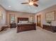 Cozy main bedroom with neutral walls, carpet, traditional furniture, and natural light from windows at 28592 Hummingbird Hill Rd, Conifer, CO 80433