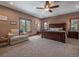 Comfortable main bedroom with neutral carpet, ceiling fan, and windows, providing a bright and relaxing space at 28592 Hummingbird Hill Rd, Conifer, CO 80433