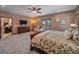 Spacious bedroom featuring a ceiling fan, a large window, and an ensuite bathroom at 28592 Hummingbird Hill Rd, Conifer, CO 80433