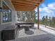 Inviting covered patio with outdoor seating and a fire pit, perfect for enjoying the scenic mountain views at 28592 Hummingbird Hill Rd, Conifer, CO 80433