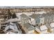 The aerial view highlights the gray siding of the townhomes and the neighborhood with snow-covered roofs at 1530 Terry St, Longmont, CO 80501