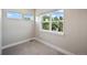 Bedroom featuring three bright windows and neutral carpet at 1530 Terry St, Longmont, CO 80501