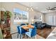 Stylish dining area with blue chairs adjacent to a comfortable living area at 1530 Terry St, Longmont, CO 80501