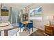 Cozy dining area with blue chairs, natural light, and a view of the outdoors at 1530 Terry St, Longmont, CO 80501