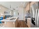 Bright kitchen with stainless steel appliances, a center island, and access to the living room at 1530 Terry St, Longmont, CO 80501