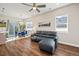 Bright and airy living room featuring wood floors, a comfortable leather couch, and a view of the dining area at 1530 Terry St, Longmont, CO 80501