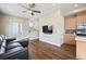 Inviting living room with hardwood floors, ceiling fan, television, and access to the kitchen at 1530 Terry St, Longmont, CO 80501