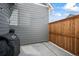 Outdoor patio space with a grill, a wood fence, and string lights, perfect for entertaining or relaxing at 1530 Terry St, Longmont, CO 80501
