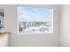 View from window in the house showing snow covered fields and mountains in the distance at 1530 Terry St, Longmont, CO 80501