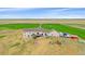 Aerial view of the property featuring a sprawling lawn, deck, playground, and multiple parked vehicles at 14551 N Harback Rd, Keenesburg, CO 80643