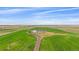 An aerial view of a home surrounded by fields and a long dirt driveway at 14551 N Harback Rd, Keenesburg, CO 80643