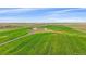 A large property with green fields and an extensive driveway approaching the residence at 14551 N Harback Rd, Keenesburg, CO 80643