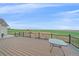 Wide back deck with black railing, offering expansive views of the lush lawn and playground set at 14551 N Harback Rd, Keenesburg, CO 80643