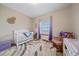 Charming Bedroom with a crib, a rocking chair, and soft lighting, creating a peaceful environment for your little one at 14551 N Harback Rd, Keenesburg, CO 80643