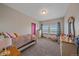 Comfortable bedroom with neutral tones, offering a peaceful retreat with two windows for natural light and fresh air at 14551 N Harback Rd, Keenesburg, CO 80643