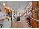 Spacious kitchen featuring stainless steel appliances, wood cabinets, and a center island, perfect for culinary enthusiasts at 14551 N Harback Rd, Keenesburg, CO 80643