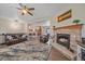 Open concept living room featuring a stone fireplace and comfortable seating area at 14551 N Harback Rd, Keenesburg, CO 80643