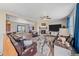 Spacious living room featuring a stone fireplace, ceiling fan and comfortable seating area at 14551 N Harback Rd, Keenesburg, CO 80643