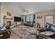 Cozy living room with a stone fireplace, large rug, and leather sofas at 14551 N Harback Rd, Keenesburg, CO 80643