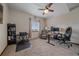 Neutral toned office space with ceiling fan, natural light, multiple desks, and carpet flooring at 14551 N Harback Rd, Keenesburg, CO 80643