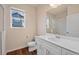 Well-lit bathroom features a shower and a toilet next to a large window at 152 Ambrose St, Erie, CO 80516