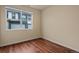 Bright bedroom with window offering a view of townhomes and two-car garages at 152 Ambrose St, Erie, CO 80516