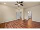 Bedroom with ceiling fan, hardwood floors and view to bathroom at 152 Ambrose St, Erie, CO 80516