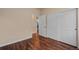 Bedroom features wood floor, neutral walls, and a closet with sliding doors at 152 Ambrose St, Erie, CO 80516