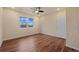 Bedroom featuring hardwood floors, ceiling fan and a large window with natural light at 152 Ambrose St, Erie, CO 80516