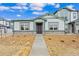 Charming home showcasing great curb appeal with stone accents and manicured landscaping at 152 Ambrose St, Erie, CO 80516