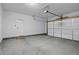 Spacious two car garage with a white door and a separate access door to the home at 152 Ambrose St, Erie, CO 80516