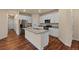 Open kitchen design with stainless steel appliances, granite countertops, and a center island at 152 Ambrose St, Erie, CO 80516
