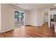 Spacious living room with sliding glass door, hardwood floors and access to kitchen at 152 Ambrose St, Erie, CO 80516